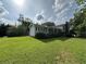 Spacious yard surrounding a light grey home with charming features at 1610 Sprayberry Dr, Marietta, GA 30066