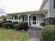 Charming home entrance featuring a brick walkway, well-manicured bushes, and a welcoming front door at 1610 Sprayberry Dr, Marietta, GA 30066