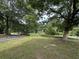View of a large front yard with mature trees, providing shade and a natural landscape at 1610 Sprayberry Dr, Marietta, GA 30066