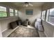 Bright and airy sunroom with multiple windows, a ceiling fan, and neutral decor at 1610 Sprayberry Dr, Marietta, GA 30066