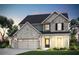 Charming two-story home featuring stone accents, a three-car garage, and professionally landscaped yard at 5220 Birch Valley Rd, Cumming, GA 30028