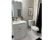 Bright bathroom features a white vanity, modern toilet, and an artistic elephant print at 539 Rue Montaigne, Stone Mountain, GA 30083