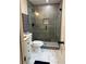 Modern bathroom with a glass shower, gray tiling, and stylish fixtures at 539 Rue Montaigne, Stone Mountain, GA 30083