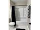 Clean bathroom features a modern tub and shower with a black shower curtain and marble-like floor at 539 Rue Montaigne, Stone Mountain, GA 30083