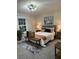 Cozy bedroom with a decorative ceiling fan, soft rug, and neutral color palette at 539 Rue Montaigne, Stone Mountain, GA 30083