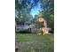 Exterior view of the home featuring a deck, lush trees, and a well-maintained lawn at 539 Rue Montaigne, Stone Mountain, GA 30083