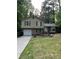 Charming split-level home featuring green shutters, brick accents, and an attached garage at 539 Rue Montaigne, Stone Mountain, GA 30083