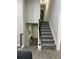 Interior hallway with stairs, neutral paint, and a glimpse of a seating area at 539 Rue Montaigne, Stone Mountain, GA 30083