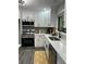 Bright kitchen features white cabinets, stainless steel appliances, and a modern faucet at 539 Rue Montaigne, Stone Mountain, GA 30083