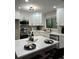 Updated kitchen featuring white cabinets, stainless steel appliances, and a bright, modern design at 539 Rue Montaigne, Stone Mountain, GA 30083