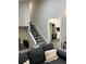 Open living area with stairs to the second floor viewed from the sofa near the kitchen at 539 Rue Montaigne, Stone Mountain, GA 30083