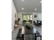 Spacious living area featuring a bay window, dining space, seating, and stylish gray flooring at 539 Rue Montaigne, Stone Mountain, GA 30083