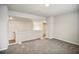A cozy living room with neutral walls, gray carpet, and an open layout providing a comfortable living space at 606 Rodeo Dr, Auburn, GA 30011