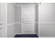 Apartment 714's front door; neutral walls, trim, and blue carpet at 2965 Pharr Nw Ct # 714, Atlanta, GA 30305