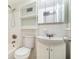 Bathroom with a white sink, toilet, tub, shower head and functional storage shelves at 2965 Pharr Nw Ct # 714, Atlanta, GA 30305