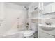 Bathroom with white tile, white toilet, tub, and shelving at 2965 Pharr Nw Ct # 714, Atlanta, GA 30305