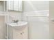 Cozy bathroom featuring a white sink with classic faucet and storage cabinet at 2965 Pharr Nw Ct # 714, Atlanta, GA 30305