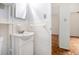 Standard bathroom with tile walls, a sink, and a view into the hall at 2965 Pharr Nw Ct # 714, Atlanta, GA 30305