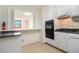 Eat-in kitchen featuring modern appliances and views into living space at 2965 Pharr Nw Ct # 714, Atlanta, GA 30305