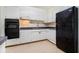 Traditional kitchen with white cabinets, tiled backsplash and black appliances at 2965 Pharr Nw Ct # 714, Atlanta, GA 30305