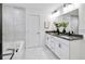 Bright bathroom featuring double sinks, bathtub/shower combo, and modern finishes at 5390 Julep Ct, Cumming, GA 30028