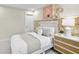 Bright bedroom features floral wallpaper, a modern dresser, and a comfy bed with decorative pillows at 5390 Julep Ct, Cumming, GA 30028