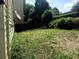 View of the backyard featuring a lush green lawn with satellite dish on side of home at 210 Ormond Sw St, Atlanta, GA 30315
