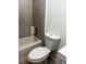 Small bathroom featuring tiled walls, a tub/shower, and a standard toilet at 210 Ormond Sw St, Atlanta, GA 30315