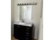 Bathroom vanity with dark wood cabinets, granite countertop, and chrome faucet at 210 Ormond Sw St, Atlanta, GA 30315