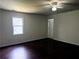 Spacious bedroom with hardwood floors, a ceiling fan, and bright window at 210 Ormond Sw St, Atlanta, GA 30315