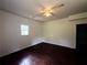 Spacious bedroom with sleek, dark wood floors and a simple ceiling fan at 210 Ormond Sw St, Atlanta, GA 30315