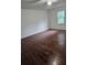 A bedroom with hardwood floors, a window, and natural lighting at 210 Ormond Sw St, Atlanta, GA 30315