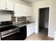 Galley kitchen featuring stainless steel appliances and ample cabinetry at 210 Ormond Sw St, Atlanta, GA 30315