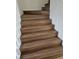 Staircase with wood look laminate treads and white risers at 210 Ormond Sw St, Atlanta, GA 30315