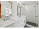 This bathroom offers double sinks, a walk-in glass shower with tile surround, and an open layout at 215 Arizona Ne Ave # 3, Atlanta, GA 30307