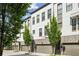 Modern townhomes with white brick, gray trim, garages, and manicured trees at 215 Arizona Ne Ave # 3, Atlanta, GA 30307