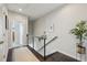 Upstairs hallway featuring modern railing, dark hardwood floors, and decorative wall art at 215 Arizona Ne Ave # 3, Atlanta, GA 30307