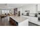 Open kitchen with white cabinets, stainless appliances, island with seating, and hardwood floors at 215 Arizona Ne Ave # 3, Atlanta, GA 30307
