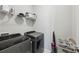 Well-lit laundry room features shelving and modern, front-loading washer and dryer at 215 Arizona Ne Ave # 3, Atlanta, GA 30307