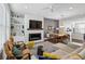 Open-concept living room with fireplace, built-in shelving, and large windows for ample natural light at 215 Arizona Ne Ave # 3, Atlanta, GA 30307