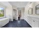 Spacious bathroom with double vanity, soaking tub, and tile flooring, offering a luxurious experience at 410 Hickory Fairway Ct, Woodstock, GA 30188