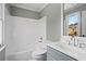 Bright bathroom with a shower-tub combo, toilet, vanity, and a large mirror offering natural light and ample space at 410 Hickory Fairway Ct, Woodstock, GA 30188