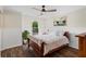 Charming bedroom with hardwood floors, a ceiling fan, and a serene view at 410 Hickory Fairway Ct, Woodstock, GA 30188