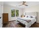 Serene bedroom featuring hardwood floors, a plush bed, and natural light at 410 Hickory Fairway Ct, Woodstock, GA 30188