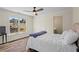 Cozy bedroom with hardwood floors, ceiling fan, and a large window offering a pleasant view at 410 Hickory Fairway Ct, Woodstock, GA 30188