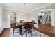 Formal dining room featuring hardwood floors, wainscoting, and modern chandelier at 410 Hickory Fairway Ct, Woodstock, GA 30188