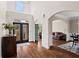 Inviting foyer with dark wood floors, archways, and a view into the living room at 410 Hickory Fairway Ct, Woodstock, GA 30188