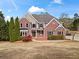 Beautiful two-story brick home with a manicured lawn and inviting entrance at 410 Hickory Fairway Ct, Woodstock, GA 30188