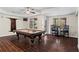 Entertainment in the game room featuring a pool table, bar seating, and hardwood-look tiled floors at 410 Hickory Fairway Ct, Woodstock, GA 30188