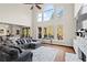Bright living room features high ceilings, fireplace, hardwood floors, and access to the outdoor deck at 410 Hickory Fairway Ct, Woodstock, GA 30188